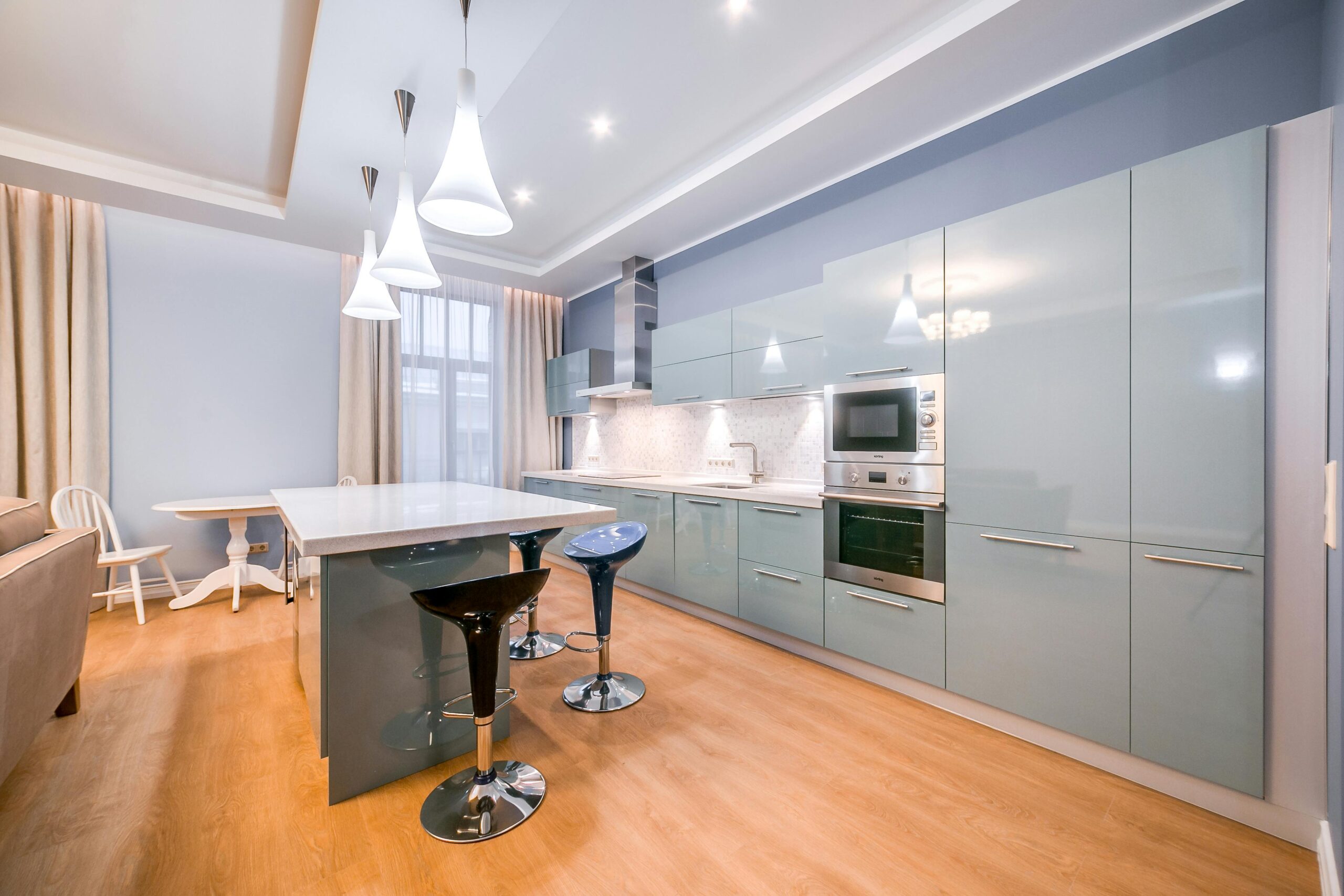 A kitchen with a large island and wooden floors